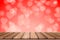 Empty Wooden board top table in front of blurred red heart background. Perspective wood in blurred bokeh heart valentine day