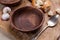 Empty wooden bowl on crushed brown paper