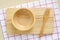 Empty wooden bowl and fork on tray, food background