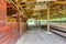 Empty wooden building with stables in the countryside.