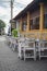 Empty wooden chairs and tables outside the restaurant in the morning, quiet and calm cobblestone Streets in Galle fort