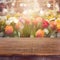 Empty wooden deck table over blurred tulip flowers background for product montage display. Spring