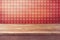 Empty wooden deck table over checked red wallpaper. Vintage kitchen interior.