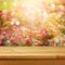 Empty wooden deck table over flowers bokeh background for product montage display. Spring or summer season