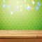 Empty wooden deck table over green shamrock wallpaper background with bokeh lights overlay. St. Patricks day concept