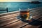 Empty wooden deck table over ocean background with glass cup of tea and saucer on wooden table, a pleasant drink, generated ai