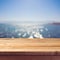 Empty wooden deck table over sea bokeh background. Summer holiday vacation