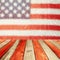 Empty wooden deck table over USA flag bokeh background. USA national holidays background. 4th of July celebration.