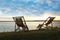 Empty wooden deckchairs on hill