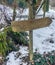 Empty wooden direction signpost with no text in a snowy forest landscape great editable background