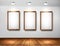 Empty wooden frames on wall with spotlights and wo