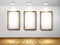 Empty wooden frames on wall with spotlights and wo