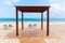 Empty wooden gazebo and sun loungers on a beach