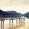 Empty wooden mole on blue Alps lake, wharf for hired boats in marina.