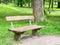 Empty wooden park bench in a city park in summer