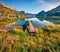 Empty wooden pier in a fishing village. Bright sunny day on Grundlsee lake. Marvelous autumn view of Eastern Alps, Liezen District