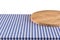 Empty wooden pizza board on blue checkered tablecloth.