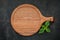 Empty wooden pizza platter set up on dark concrete. Pizza tray on dark concrete background flat lay and copy space