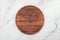 Empty wooden pizza platter set up on marble stone kitchen table. Pizza board on white marble background flat lay and copy space