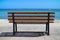 Empty wooden rest bench at sea shore