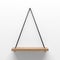 Empty wooden shelf hanging on rope