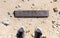 Empty wooden signboard against tropical sand beach