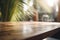 Empty Wooden table in a cafe shop close-up. Summer tropics palm trees. Blurred background