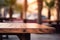Empty Wooden table in a cafe shop close-up. Summer tropics palm trees. Blurred background