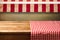 Empty wooden table covered with red checked tablecloth. Background for product montage