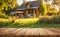 An empty wooden table in the foreground, with a blurred country house in the background against a verdant garden setting