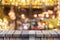 Empty wooden table in front of coffee shop abstract blur background