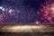 Empty wooden table in front of fireworks background