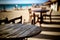 Empty wooden table on outdoor beach cafe and chair with blurred nigh city and boke