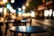 Empty wooden table on outdoor cafe and chair with blurred nigh city and boke