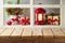 Empty wooden table over window with lantern and gift box background.  Christmas holiday mock up for design and product display