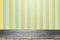 Empty wooden table over yellow and aqua background.