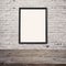 Empty wooden table with poster mock up template over brick wall