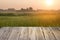 Empty wooden table ricefield and sunrise background