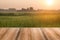 Empty wooden table ricefield and sunrise background