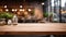 Empty wooden table surface closeup, blur cafe bar restaurant or retail shop interior background, bokeh lights