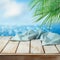 Empty wooden table with tablecloth over tropical beach bokeh background.  Summer mock up for design and product display