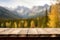 The empty wooden table top with blur background of Alaska nature. Exuberant.