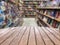 Empty wooden table top with Blur bookshelves in bookstore background. An empty tabletop in a library