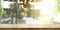 Empty wooden table top with blur coffee shop or restaurant inter