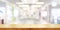 Empty wooden table top with blurred modern shopping mall background. Panoramic banner