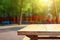 Empty wooden table top with colourful children playground field blurred background. Template for product presentation display