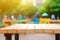 Empty wooden table top with colourful children playground field blurred background. Template for product presentation display