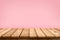 Empty wooden table top on pastel pink colour background, used for display or montage your products