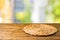 Empty wooden table with wicker round placemat over abstract bokeh background