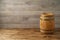 Empty wooden table with wine barrel over wooden board background